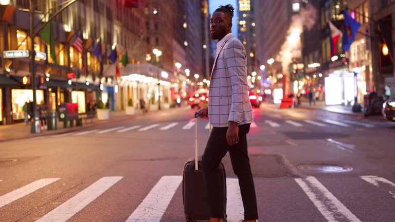 Affluent black businessman on a trip to NYC, zebra crossing