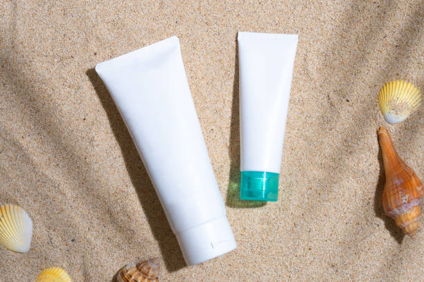 istock Sunscreen container mockup with sea shells and palm leaves shadow 1603668298