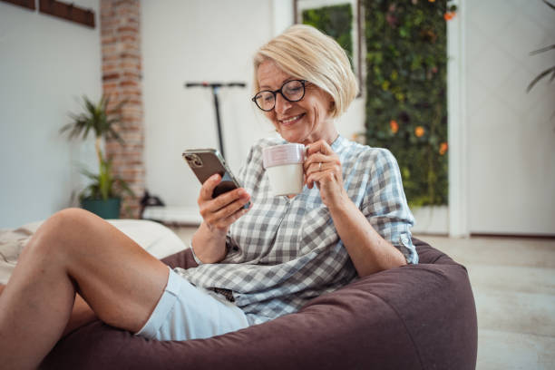 istock Mature woman using smart phone 1603672640