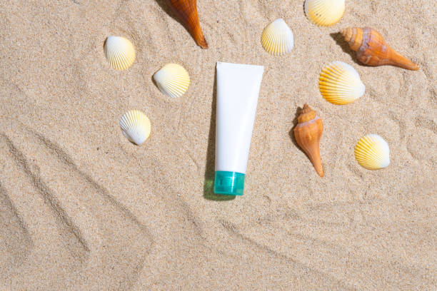 istock Sunscreen container mockup with sea shells and palm leaves shadow 1603678615