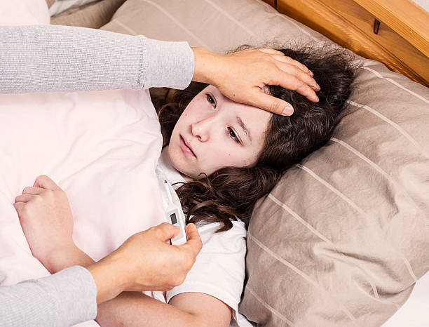 istock Young Girl feeling fever in bed 160368207