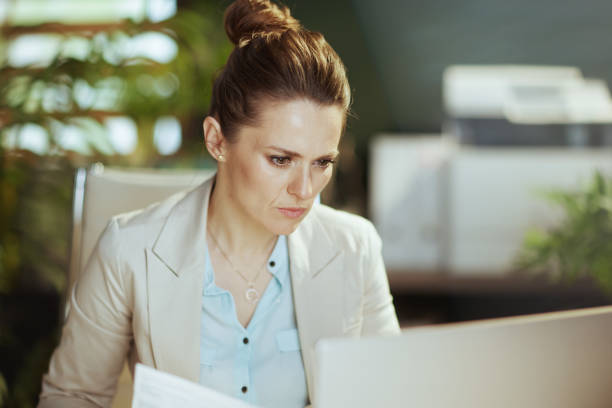 istock pensive modern bookkeeper woman in modern green office 1603695365
