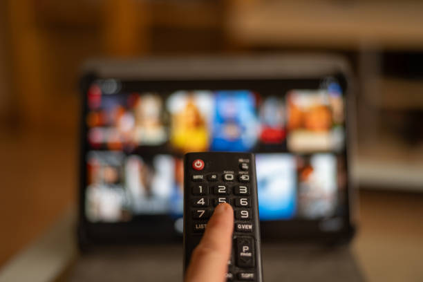 istock Television Remote Control In The Hands Of A Client Who Is Looking For Some Multimedia Content To Stream Video. 1603701288