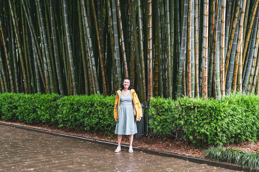 woman is posing against large bamboo forest in Batumi Georgia