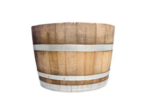 Half a wine barrel, maybe used as a planter, on white background.
