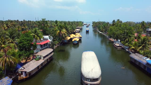 Aerial view of traditional houseboat cruising Kerala backwaters. Travel India