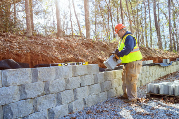 istock When developing new property construction worker uses cement blocks to build a retaining wall. 1603727827