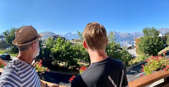 Father and son watching the Alps landscape