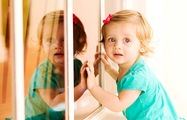istock Toddler Girl with Reflection in Window 160376448