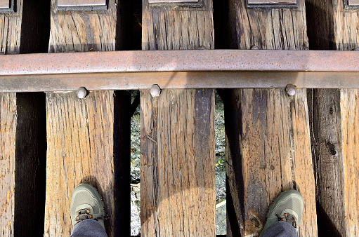 Looking down on an abandoned railroad bridge, over a creek.