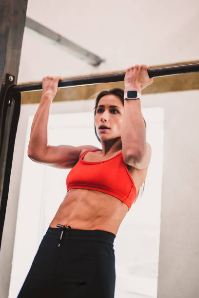 istock Slender girl on the horizontal bar pulls herself up training endurance 1603796795