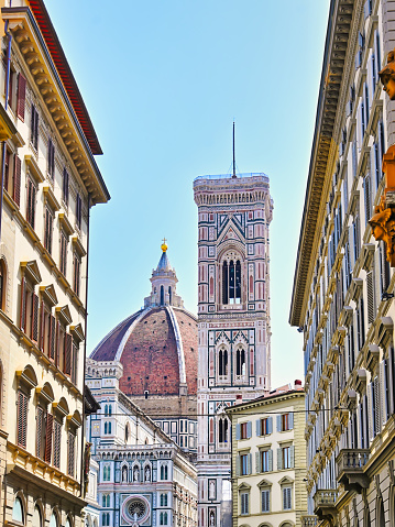 This photo captures the awe-inspiring sight of Florence's renowned cathedral, showcasing its intricate facade and towering dome. The cathedral, completed in 1436, is a masterpiece of Gothic architecture and a symbol of the city's cultural heritage. The image offers a perspective of the cathedral's grandeur as seen from the bustling streets of Florence, Italy.