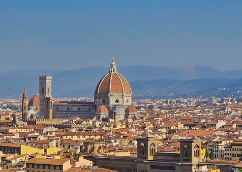 This photo captures the panoramic vista from the elevated Piazzale Michelangelo, offering a stunning view of the iconic Brunelleschi's Dome atop Florence's cathedral. The dome, designed by Filippo Brunelleschi in the 15th century, stands as a marvel of Renaissance engineering. The image showcases the harmonious blend of architecture and landscape that defines the city's beauty and history