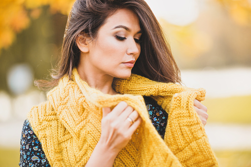 Attractive eastern woman with a yellow woolen scarf