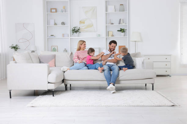 istock Happy family having fun together on sofa at home 1603810204