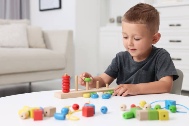 istock Motor skills development. Little boy playing with stacking and counting game at table indoors 1603811237