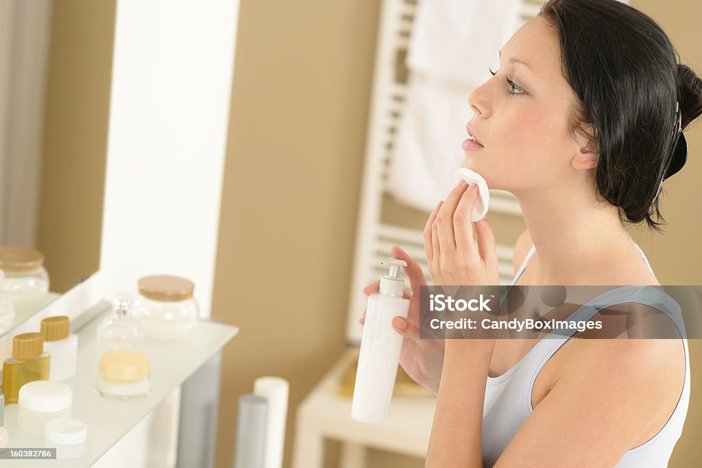 Giovane donna pulizia viso bagno make-up di rimozione - Foto stock royalty-free di Pulire