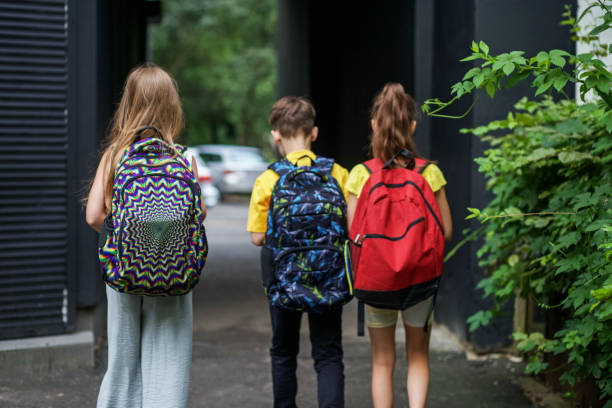 istock Children go to school for study. Classmates with backpacks. Concept of school, study, education 1603833509