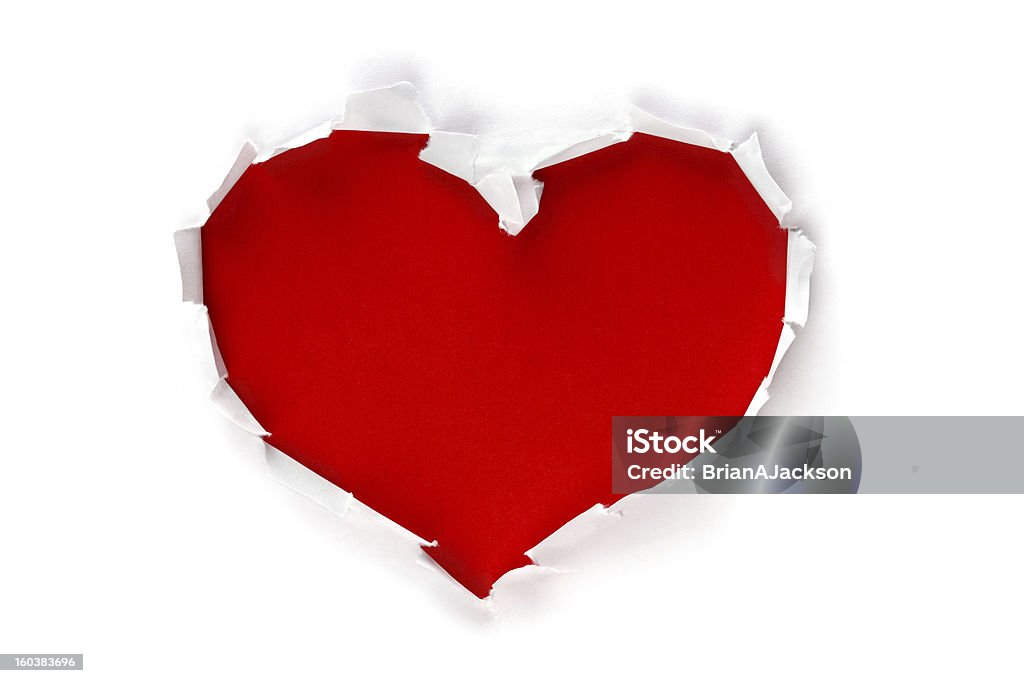 En forma de corazón a través del orificio en papel - Foto de stock de Símbolo en forma de corazón libre de derechos