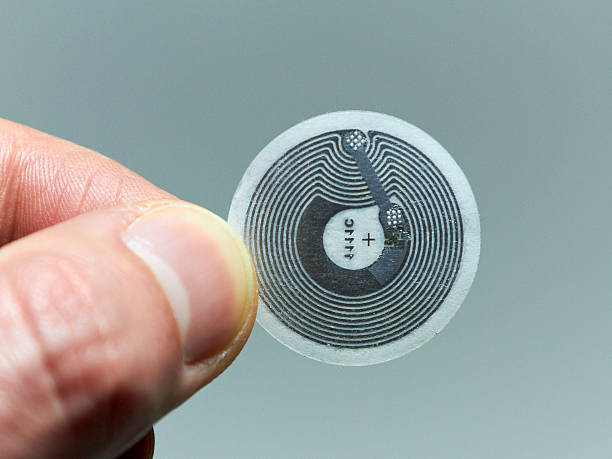 NFC - Near field communication / Computer Chip NFC - Near field communication tag - computer chip in human hand radio frequency identification stock pictures, royalty-free photos & images
