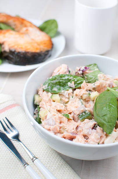 Cut salmon salad with onions and cucumber vertical