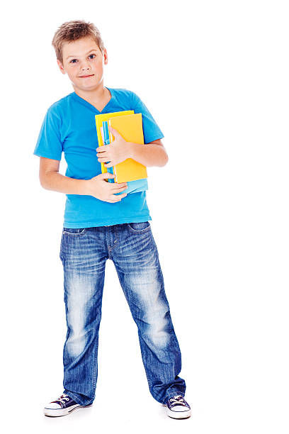 Student in jeans and blue t-shirt, holding books