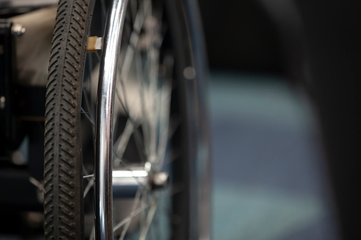 Wheelchair wheel, close-up, copyspace. The concept of inclusion.