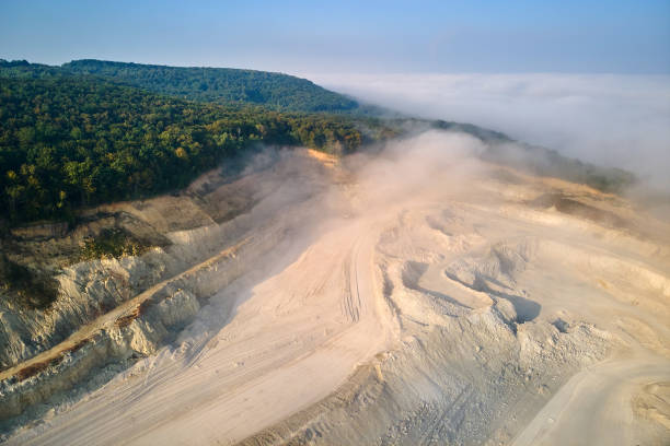istock Aerial view of open pit mining site of limestone materials extraction for construction industry with excavators and dump trucks. 1603865492