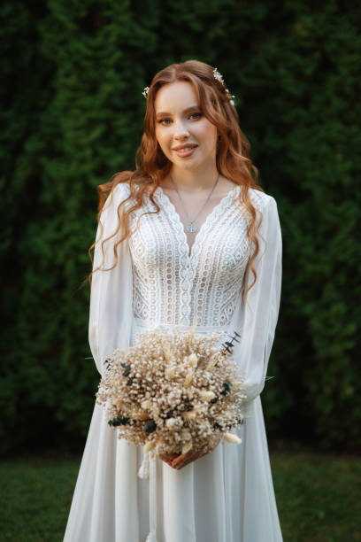 istock red-haired girl bride with a wedding bouquet 1603868754