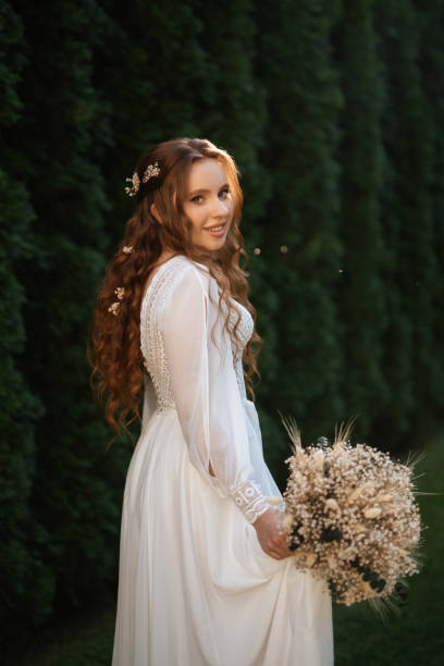 istock red-haired girl bride with a wedding bouquet 1603873518