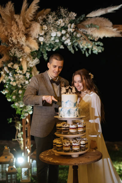 istock newlyweds happily cut and taste the wedding cake 1603883997