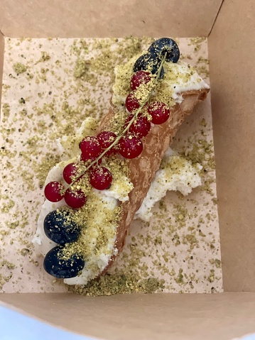 Cannolo in a takeaway box