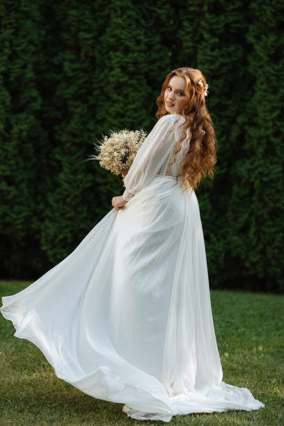 istock red-haired girl bride with a wedding bouquet 1603889742