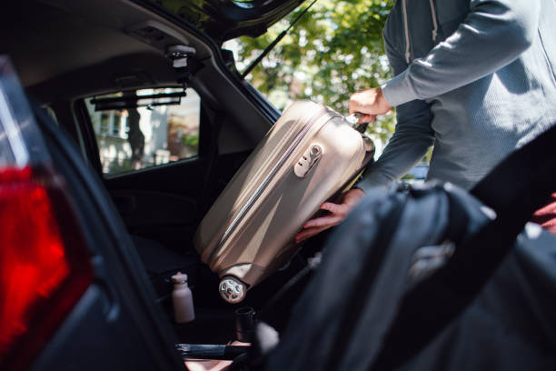 istock Anonymous Man Putting a Small Suitcase in the Car 1603911103
