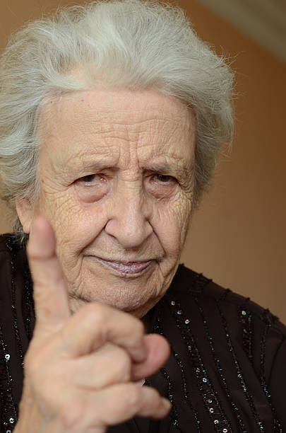 istock angry senior woman making warning sign 160392886