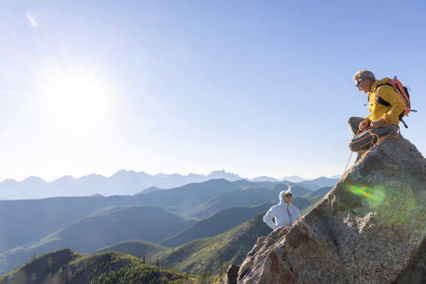 istock Mature couple climb to mountain summit 1603931514