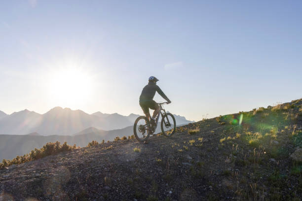 istock Male mountain biker ascends high mountain ridge 1603938920