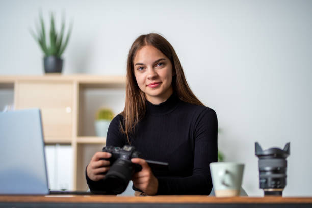 istock girl photographer look her work on the camera 1603950515