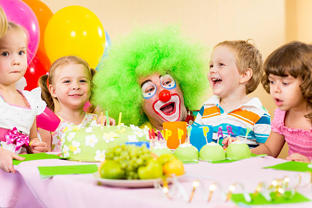 kids celebrating birthday party with clown