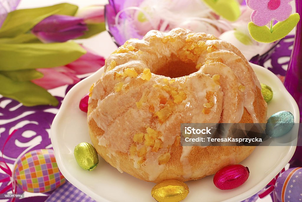 yeast ring cake for easter yeast ring cake decorated with icing and candied orange peel  for easter Baked Stock Photo
