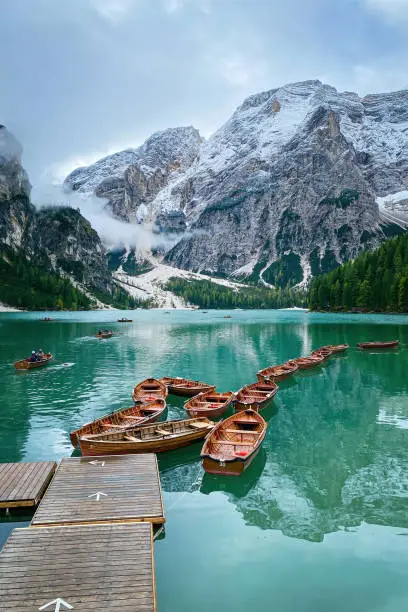 Photo of Scenic view of boats tethered on floating pier at Lake Braies boathouse, Italy