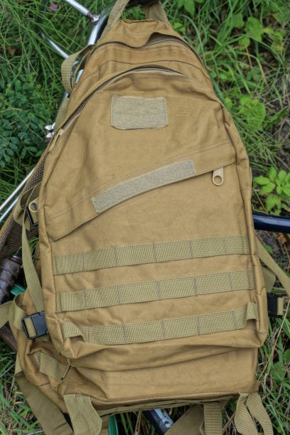 istock one brown army backpack hanging on the handlebars of a bicycle 1604132520