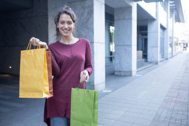 istock Young woman coming back from shopping 1604171095