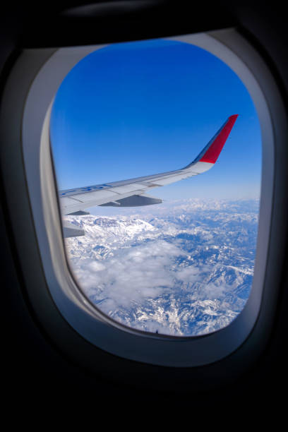 istock Classic image through aircraft window onto wing. Flight view over Turkey 1604174269