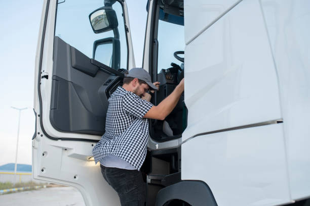 istock Truck driver getting in his truck. 1604174291