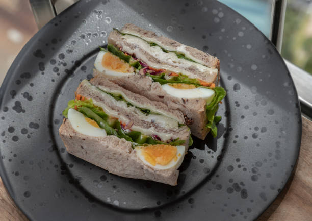 istock Homemade sandwich's stuffed with chicken breast, cheese, boiled eggs and fresh vegetables. 1604182957