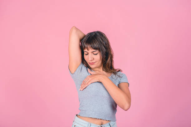 istock Woman doing a Breast Self-Exam over pink background 1604193081