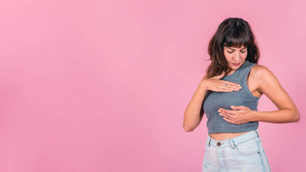 Woman doing a Breast Self-Exam (BSE). Copy-space. Woman doing a Breast Self-Exam (BSE). Copy-space. Self Exam stock pictures, royalty-free photos & images