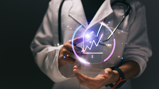 Close up of female doctor holding stethoscope and cardiogram