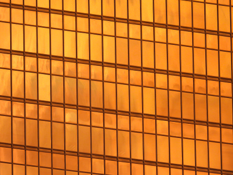 Reflection at sunset in a skyscraper in Admiralty on Hong Kong Island, the Far East Finance Centre. The colour of the windows is originally orange, not caused by the setting sun. This image was taken on a hot, humid and sunny day at sunset on 7 July 2023.